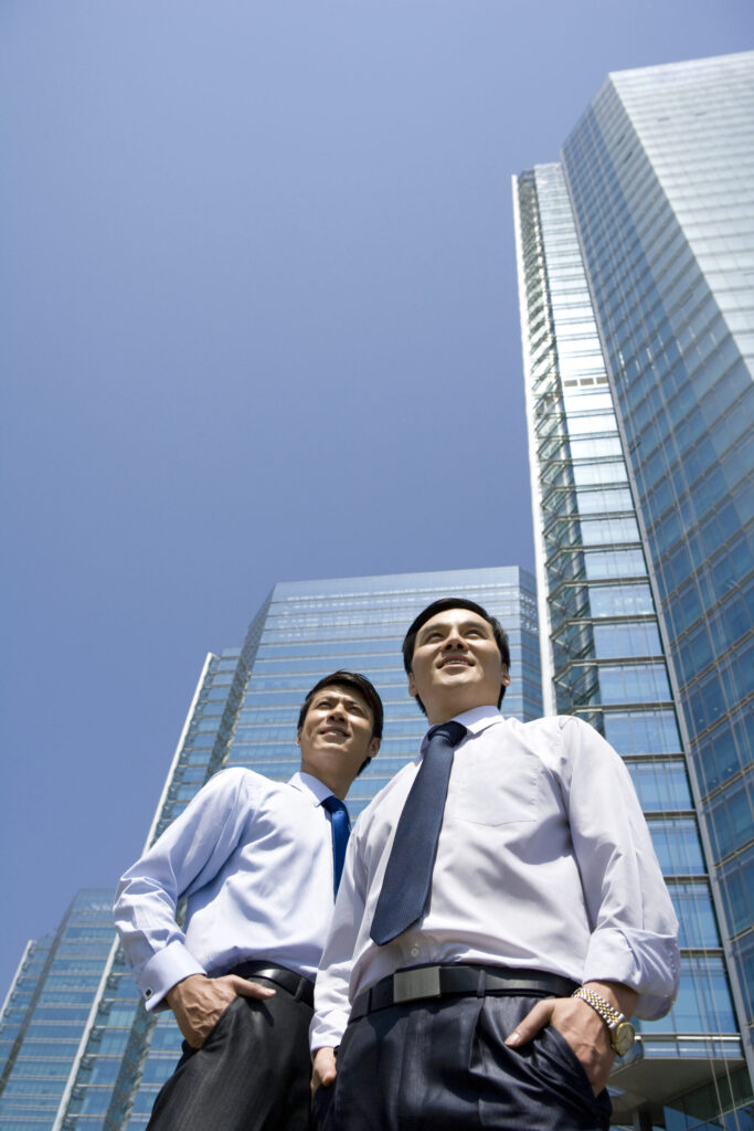 chinese businessmen in front of a office tower 2026 01 11 11 12 46 utc scaled.jpg
